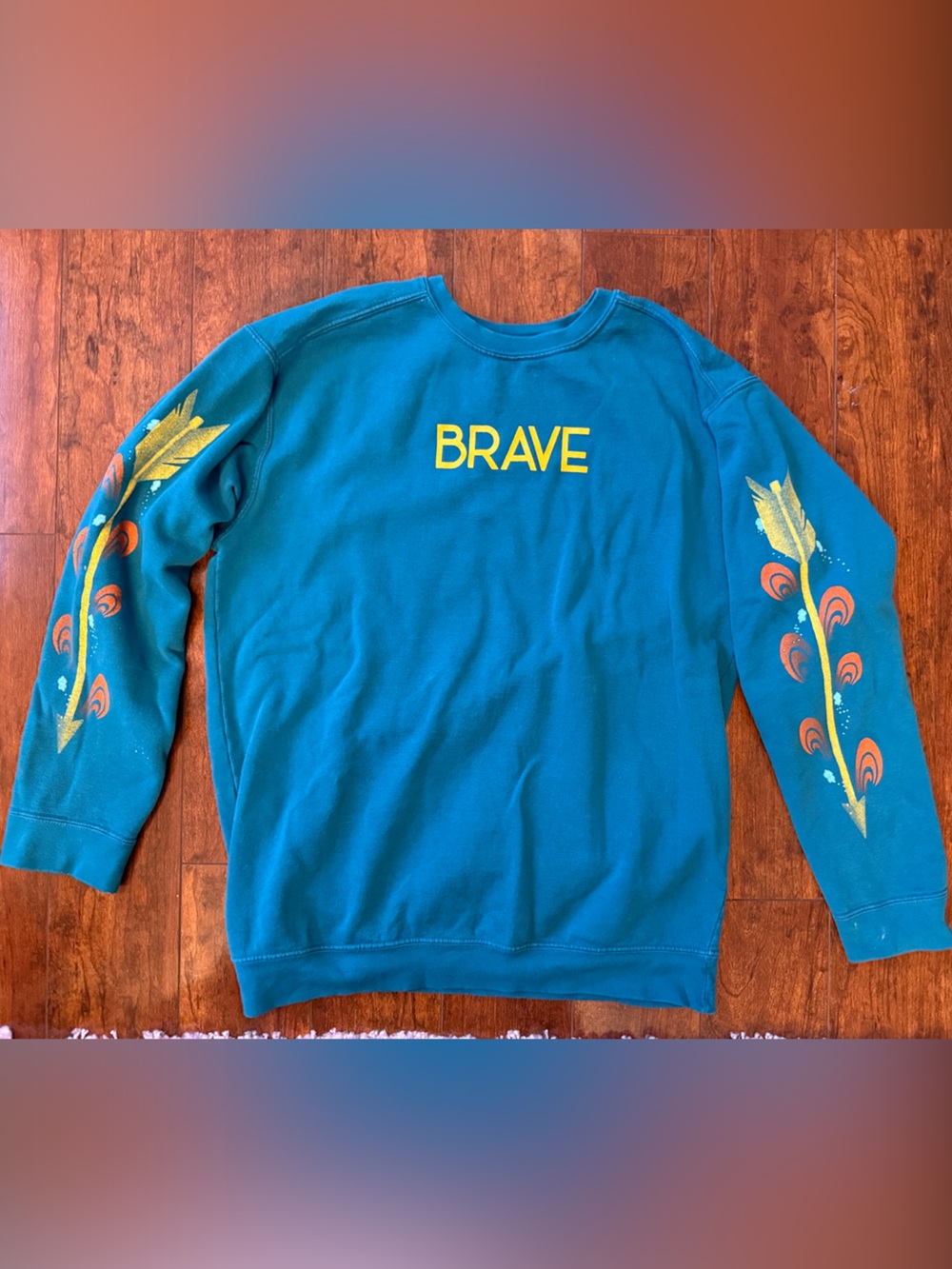 The Lost Bros Teal "BRAVE" Sweatshirt with Feather Sleeve Prints